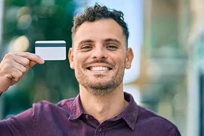 man holding up his credit card