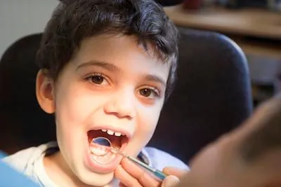 child getting a checkup after a frenectomy at Centro Dental Las Americas