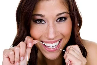 woman flossing her teeth