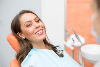 patient smiling in the dental chair during her first visit at Centro Dental Las Americas
