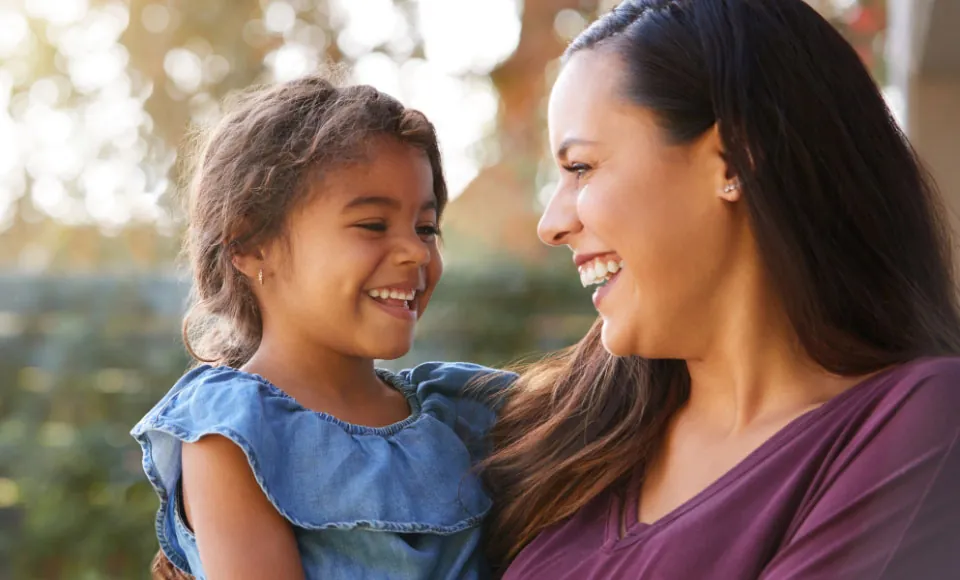 woman smiling with her daughter after visiting Centro Dental Las Americas in Hyattsville to get her teeth cleaned