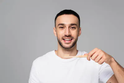 man brushing his teeth