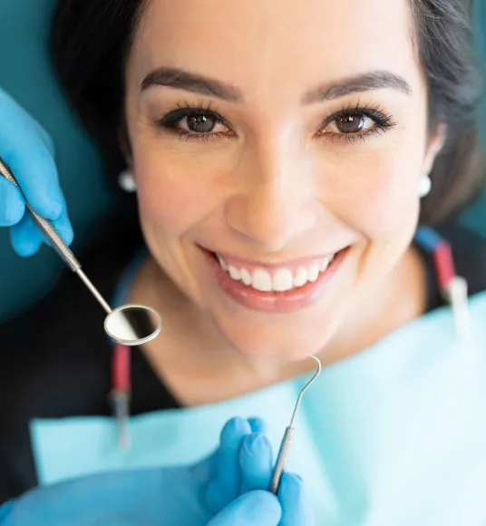 patient smiling in the dental chair during her visit to Hyattsville dental office Centro Dental Las Americas